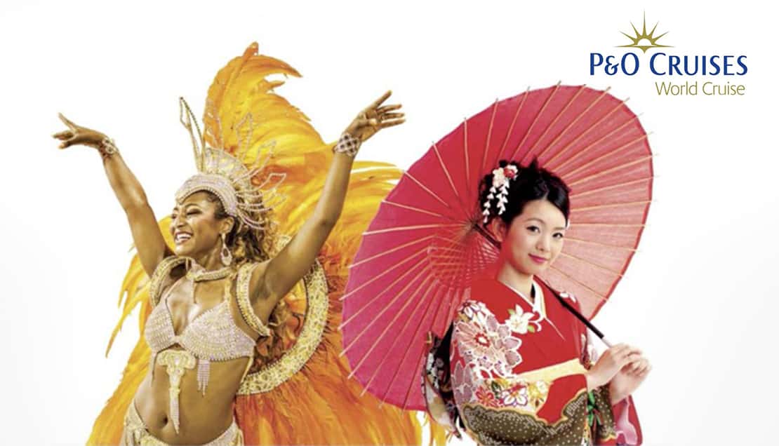 Two performers in carnival costume, one in gold feathers and one in a kimono holding a red parasol.